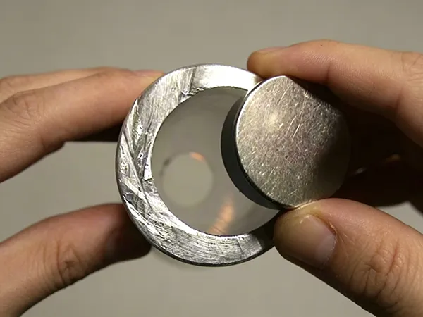 Close-up of an aluminum piece and a magnet used to demonstrate magnetic response