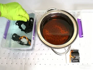 Black oxide coating process with chemical bath and blackening coating treatment in progress