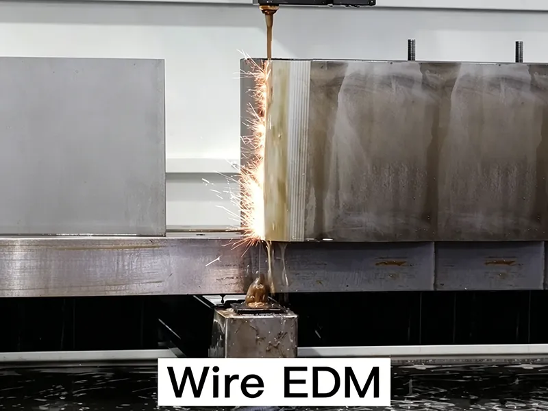 Wire EDM cutting process on thick metal block with spark discharge