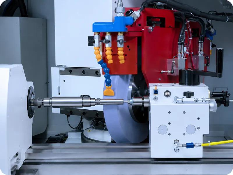 CNC grinding machine polishing a metal workpiece with coolant