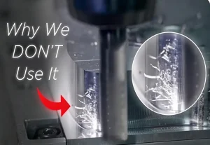 CNC milling operation showing chip buildup and poor cutting conditions on a machined metal surface