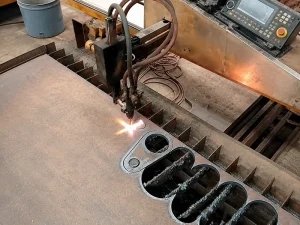 CNC Plasma Cutting machine cutting steel plate on an industrial table