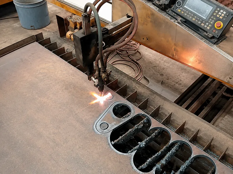 CNC Plasma Cutting machine cutting steel plate on an industrial table