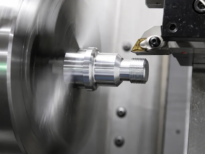 Swiss-type CNC lathe turning small cylindrical metal components