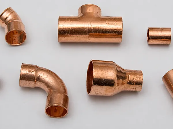 Copper pipe fittings and connectors on a white background