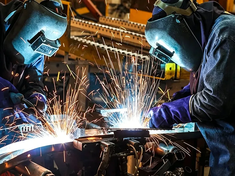 Industrial welding process with sparks during metal fabrication