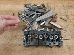 Lathe cutting tools arranged on a workbench for CNC turning operations