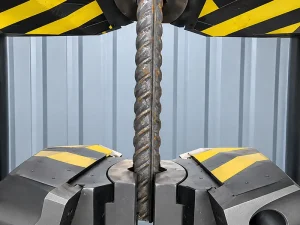 Mild steel rebar being tested for strength and mechanical performance