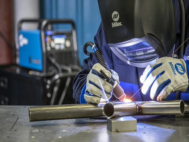 TIG welding process on a metal tube joint with precise arc control