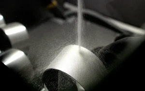 Bead Blast Finish being applied to a curved metal component