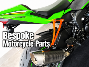 Bespoke Motorcycle Parts with a custom orange mounting bracket on a sport bike