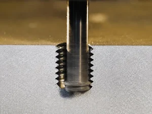 Cast metal component with internal threaded holes for bolt assembly