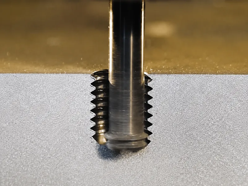 Cast metal component with internal threaded holes for bolt assembly