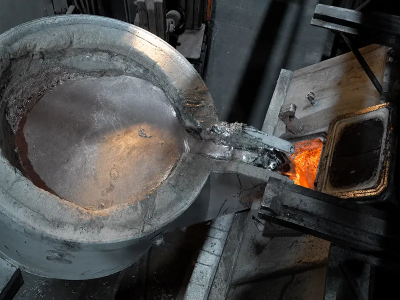 Molten metal casting process in an industrial foundry workshop