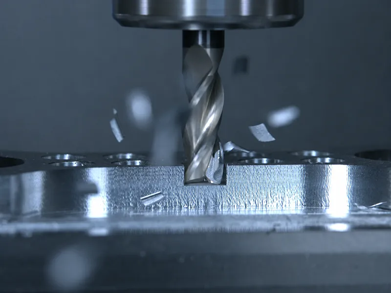 End mill removing material from a metal workpiece during CNC machining