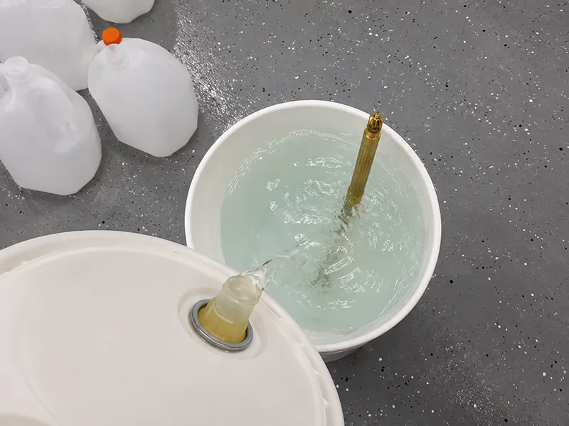 Machining coolant being mixed and tested in a workshop container
