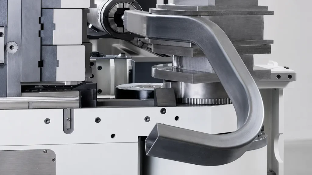 Rectangular metal tube being formed by precision bending tooling