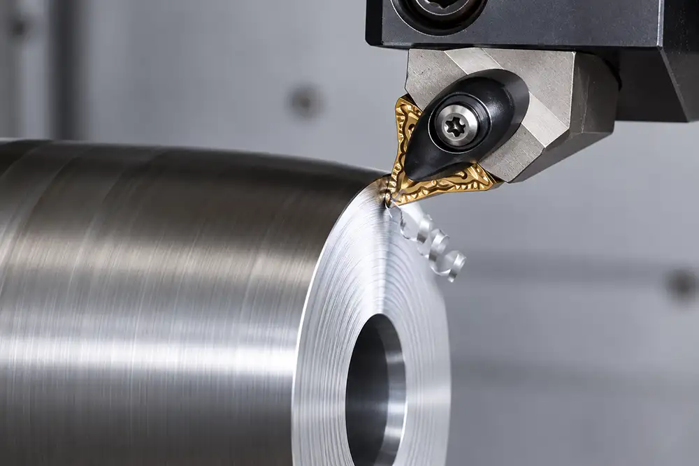 CNC lathe cutting insert machining the face of a cylindrical metal workpiece